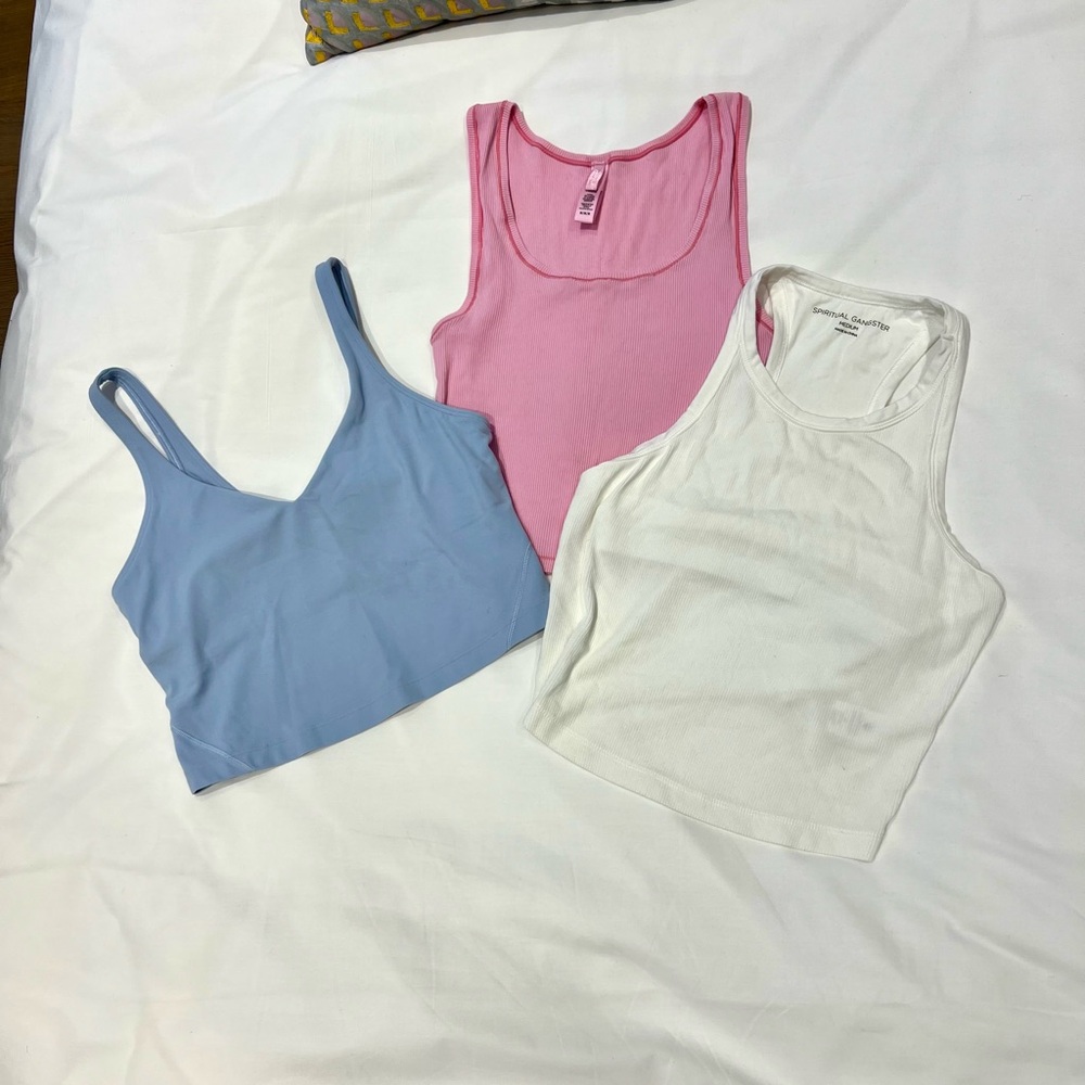 3 sport yoga tops. Skims/Pink Lululemon/Blue Spiritual Gangster/White. Small fit